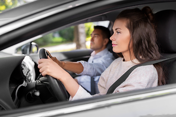 Image showing car driving school instructor teaching woman