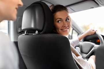 Image showing female driver driving car with passenger