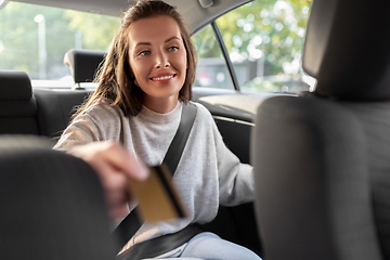 Image showing female passenger giving credit card to taxi driver