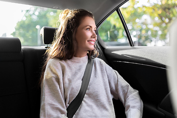 Image showing smiling woman or female passenger in taxi car