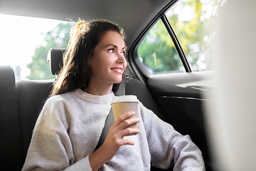 Image showing woman or passenger drinking coffee in taxi car