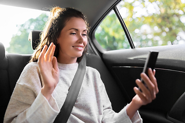 Image showing woman in taxi car having video call on smartphone