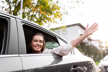 Image showing happy smiling woman or female passenger in car