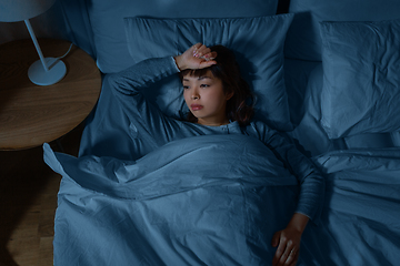 Image showing sleepless asian woman lying in bed at night