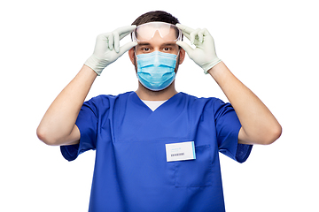 Image showing male doctor in goggles, mask and gloves