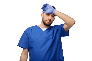 Image showing tired doctor or male nurse in blue uniform