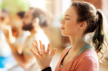 Image showing woman with group meditating at yoga studio