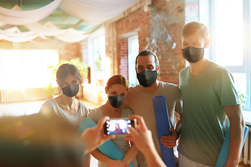 Image showing people in masks at yoga studio photographing