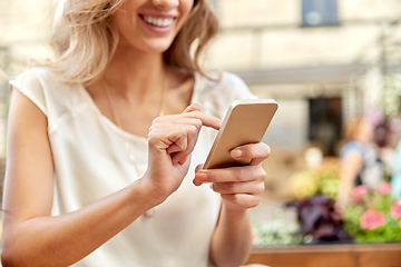 Image showing happy woman with smartphone at street cafe