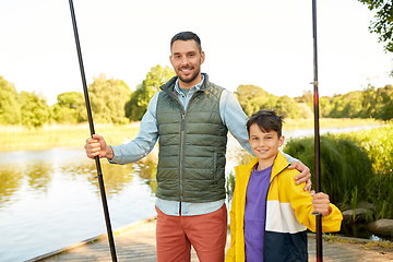 Image showing happy smiling father and son fishing on river