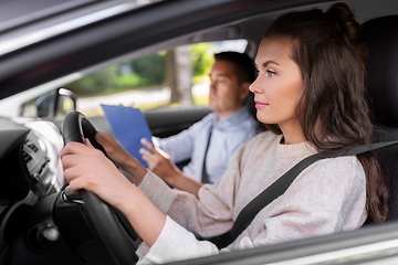 Image showing car driving school instructor and young driver