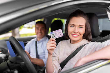 Image showing car driving instructor and driver with license