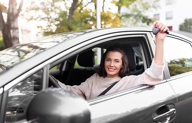 Image showing woman or female driver with car key in city