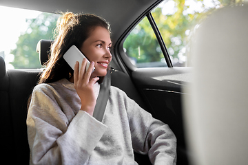 Image showing woman in taxi car calling on smartphone