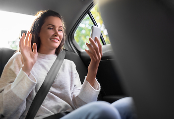 Image showing woman in taxi car having video call on smartphone