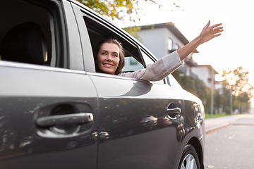 Image showing happy smiling woman or female passenger in car