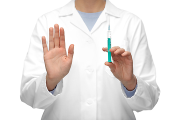 Image showing close up of doctor with syringe shows stop gesture