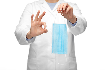 Image showing female doctor with medical mask showing ok gesture