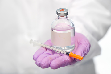 Image showing close up of doctor with medicine and syringe