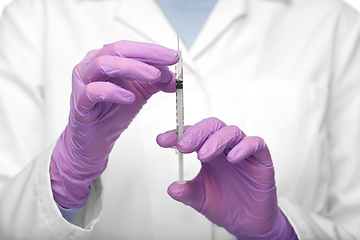 Image showing close up of doctor with syringe