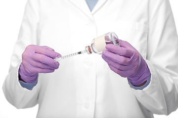 Image showing close up of doctor with medicine and syringe