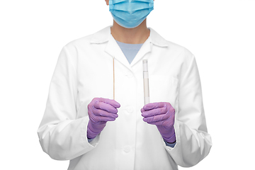 Image showing female doctor with test tube and cotton swab