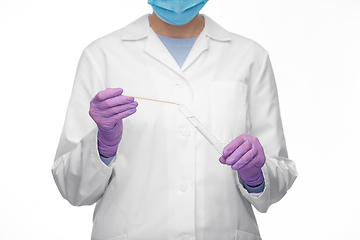 Image showing female doctor with test tube and cotton swab