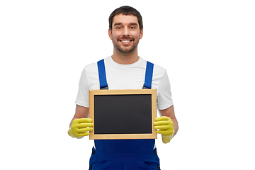 Image showing smiling worker or male cleaner showing chalkboard