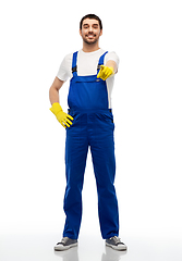 Image showing happy male worker or cleaner pointing to you