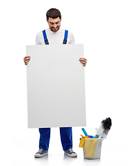 Image showing male cleaner with cleaning stuff and white board