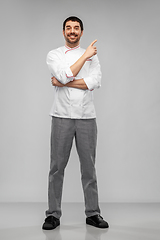 Image showing happy smiling male chef pointing to something
