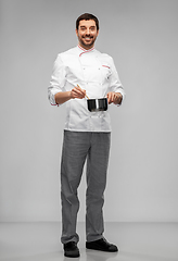 Image showing happy smiling male chef with saucepan cooking food