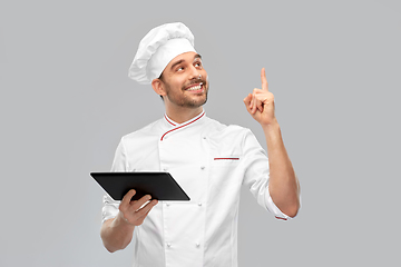 Image showing male chef with tablet computer pointing finger up