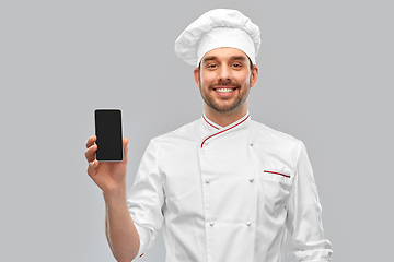 Image showing happy smiling male chef showing smartphone