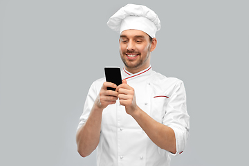 Image showing happy smiling male chef with smartphone