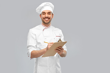 Image showing happy smiling male chef with clipboard and pencil