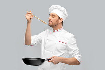 Image showing happy male chef with frying pan tasting food