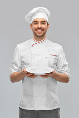 Image showing happy smiling male chef holding empty plate