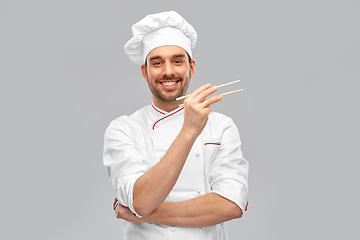 Image showing happy smiling male chef with chopsticks