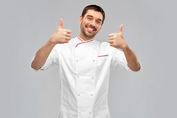 Image showing smiling male chef in jacket showing thumbs up