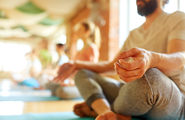 Image showing group of people making yoga exercises at studio