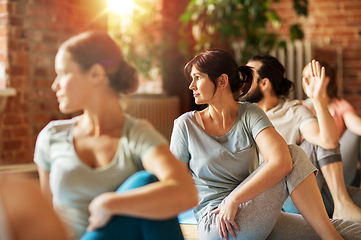 Image showing group of people doing yoga exercises at studio