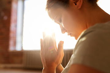 Image showing close up of woman meditating at yoga studio