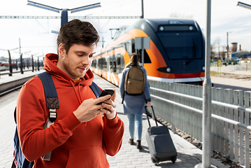 Image showing man with smartphone traveling by train