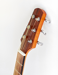 Image showing close up of acoustic guitar head with pegs