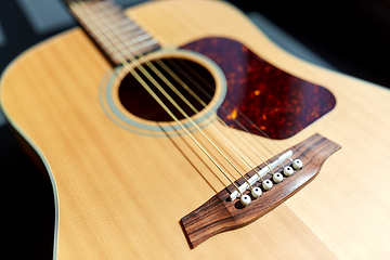 Image showing close up of acoustic guitar on window sill