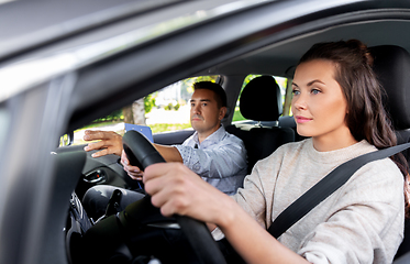 Image showing car driving school instructor and young driver