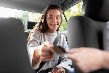 Image showing female passenger giving credit card to taxi driver