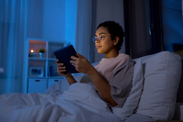 Image showing woman with tablet pc in bed at home at night