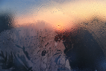 Image showing Ice patterns, water drops and sunlight on glass 